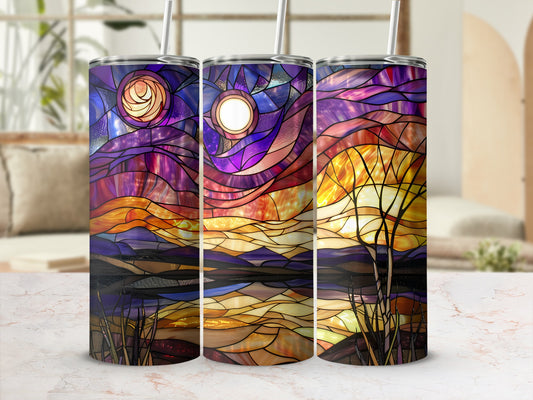 Three stained-glass tumblers with sunset landscape designs.