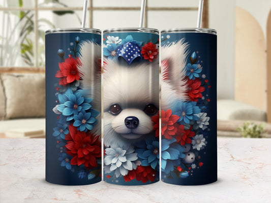 Fluffy white dog surrounded by red, white, and blue flowers on a dark blue tumbler.