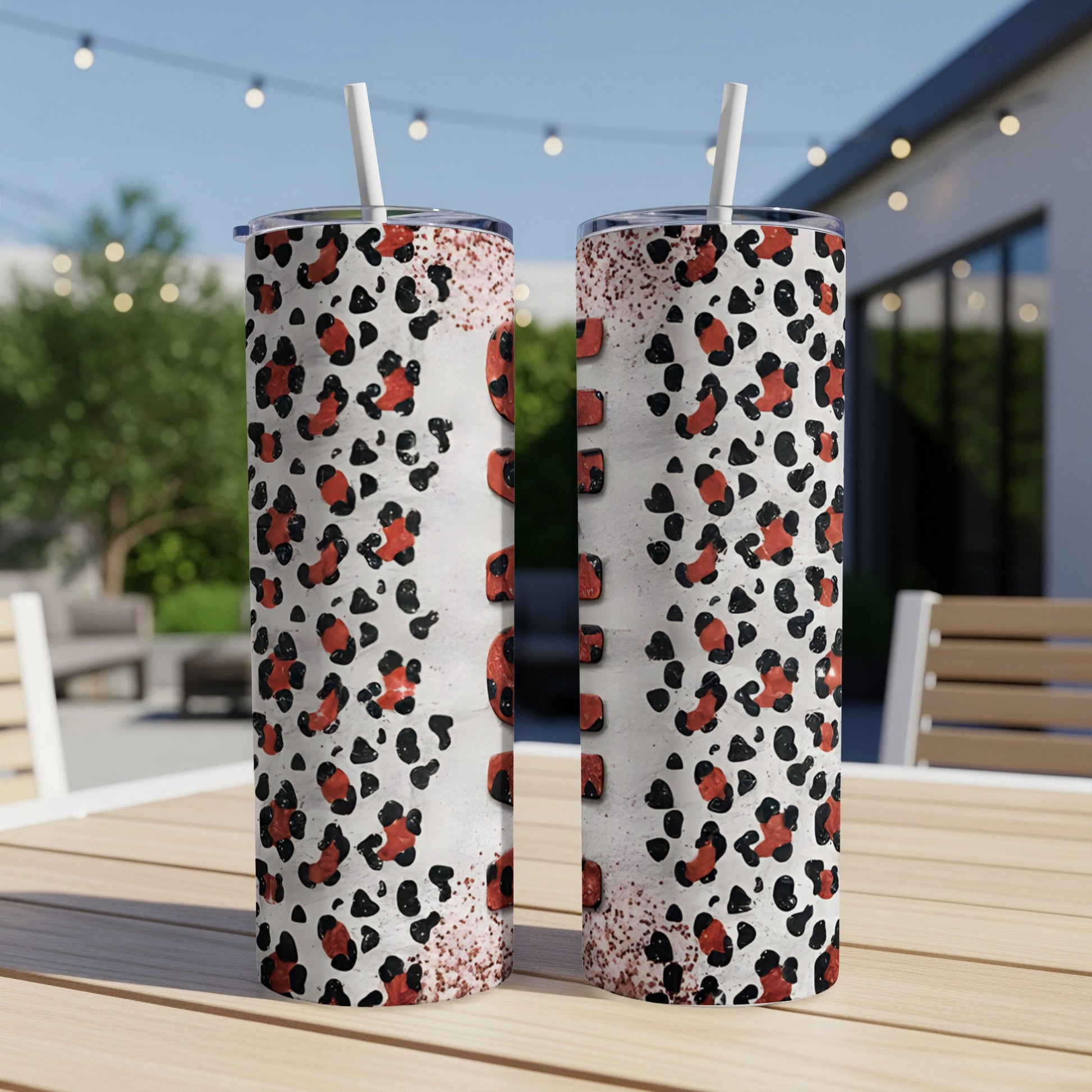 Two tumblers with leopard print, straw, and textured background.