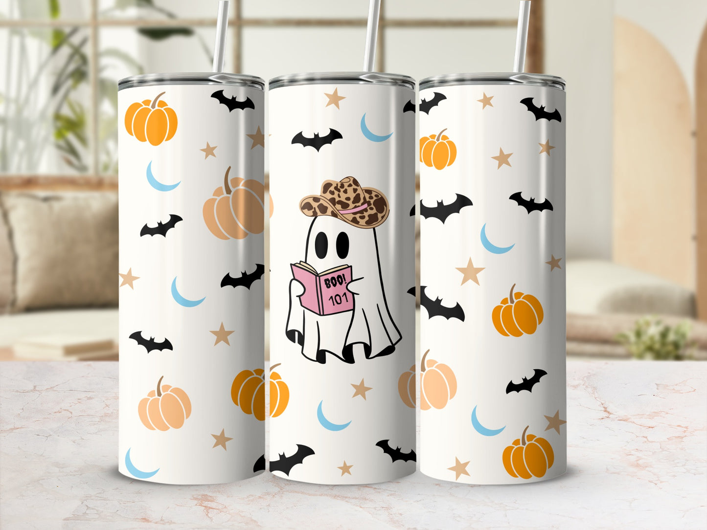 Three tumblers with white background and Halloween pattern of pumpkins, bats, and moons.