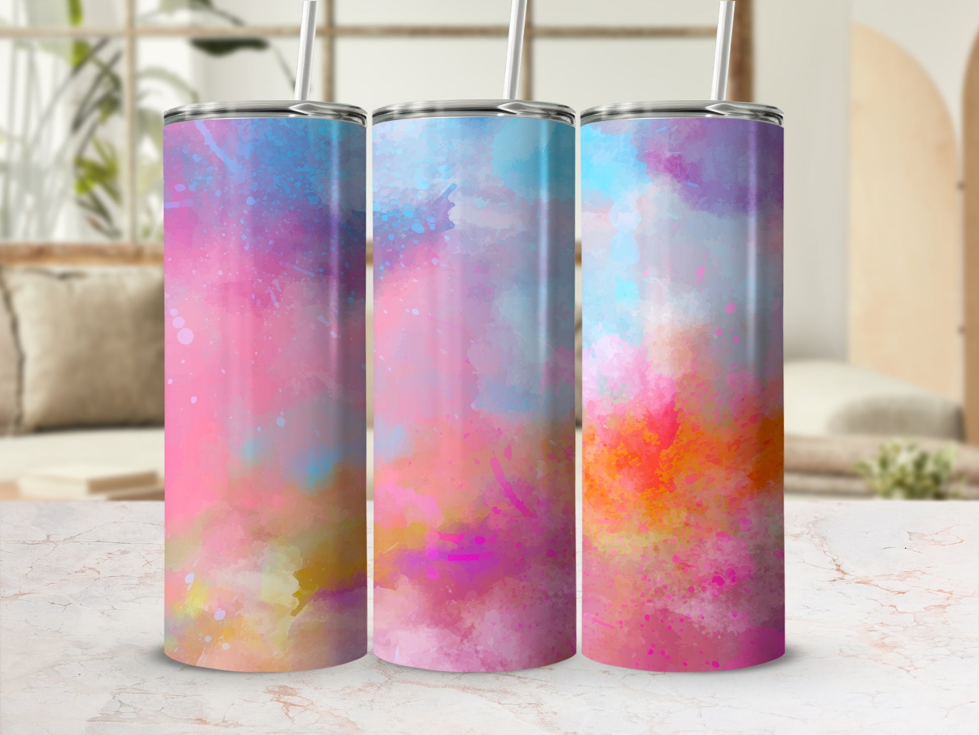 Three tumblers with colorful, abstract watercolor paint splatter designs.