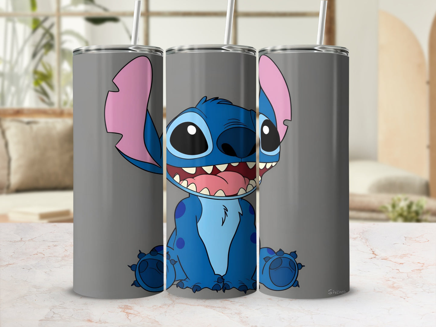 Blue Stitch character on a gray tumbler with straw.