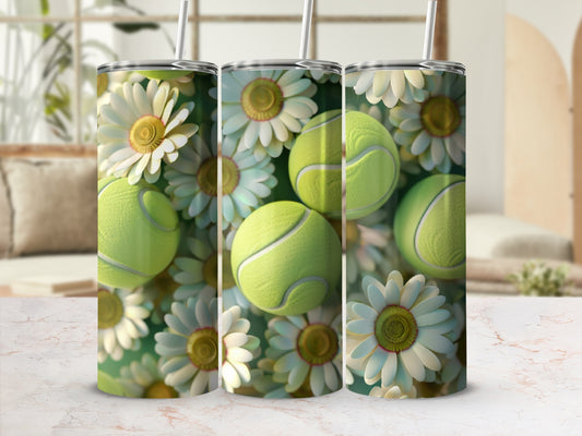 Three tumblers with tennis balls and daisies on a marbled surface.