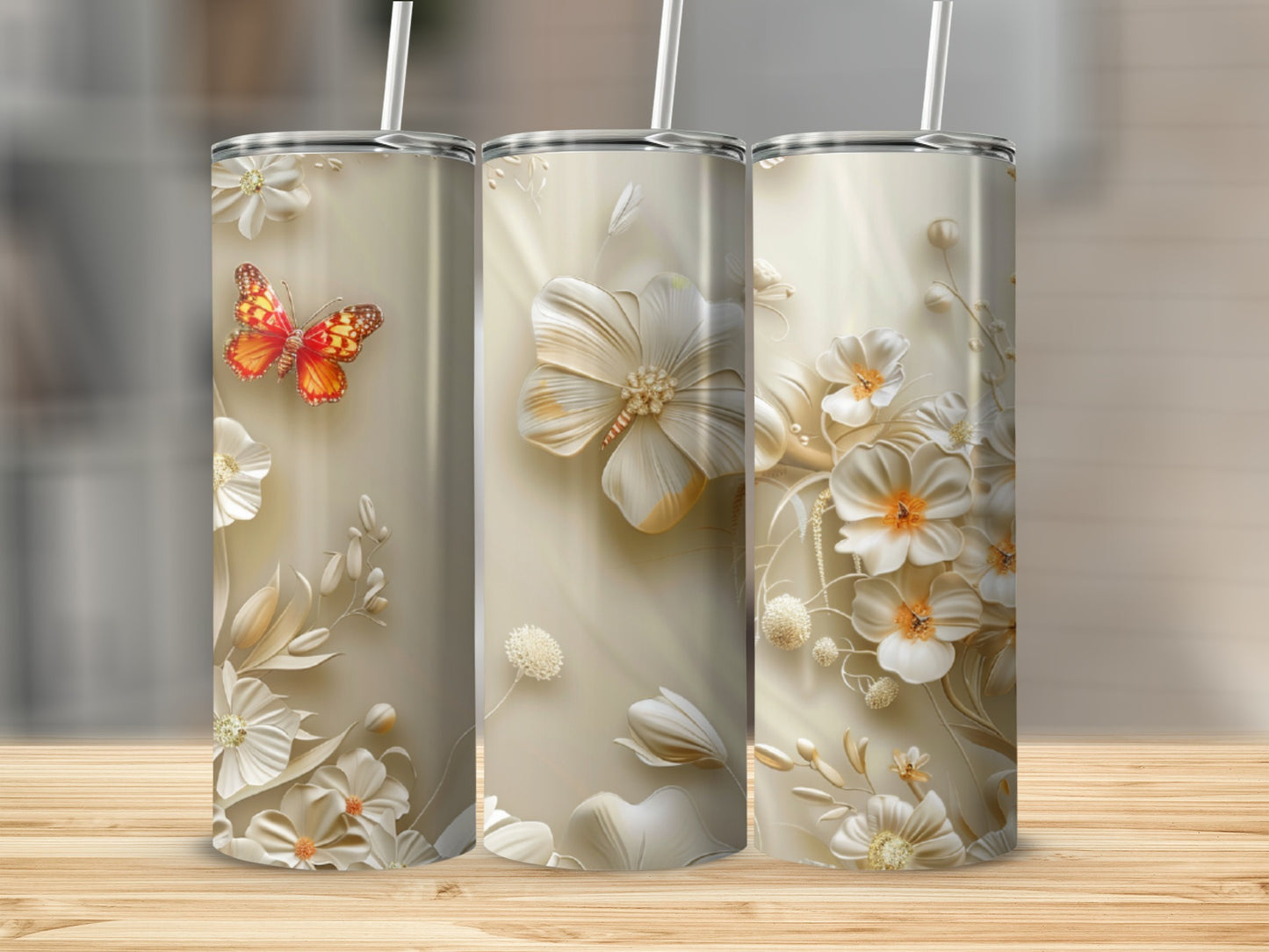 Three tumblers with cream-colored floral designs and a butterfly.