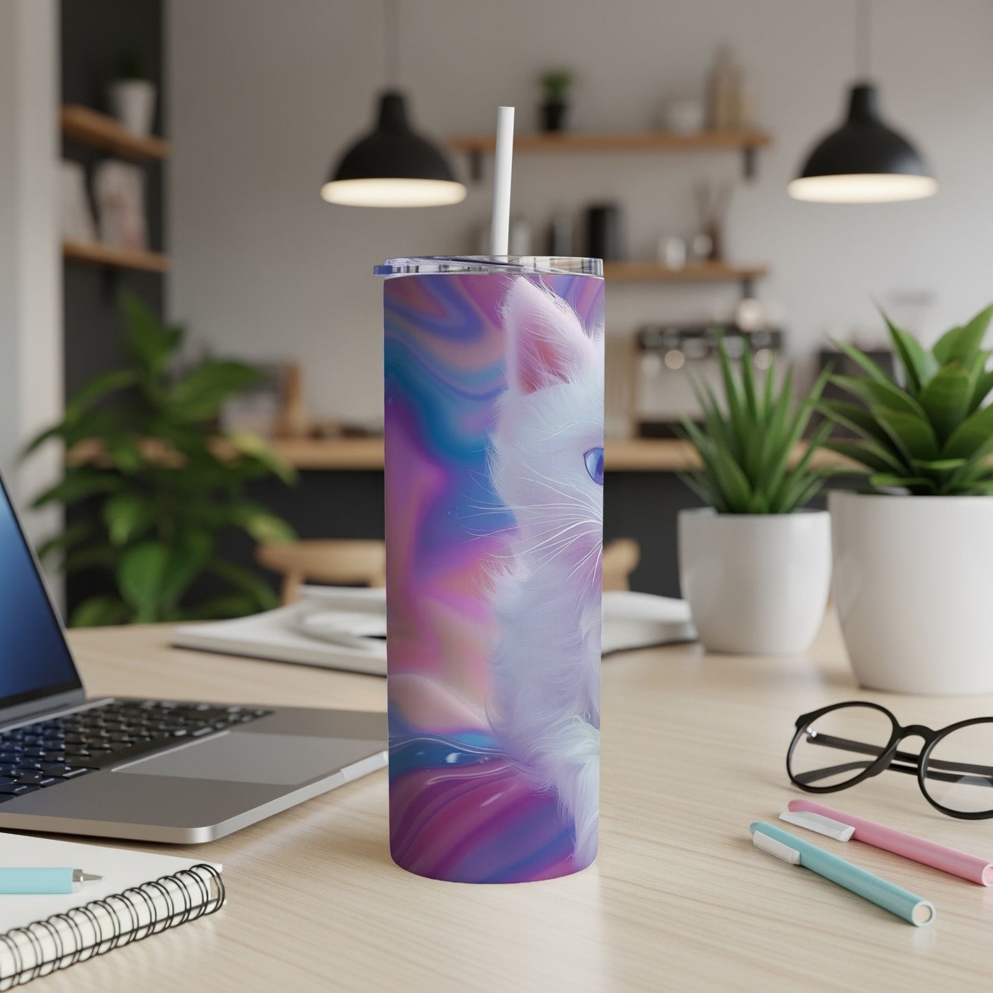 White cat on abstract colorful patterned tumbler with straw.