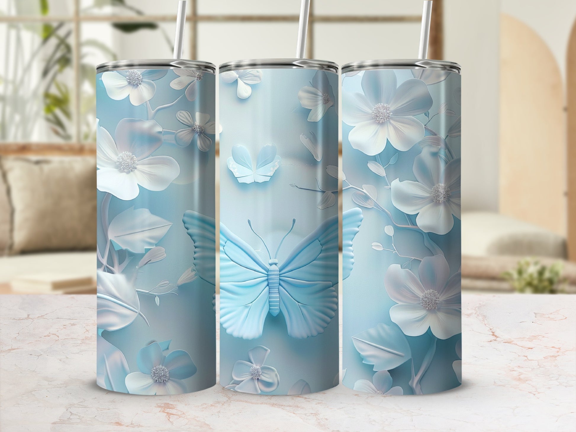 Three light blue tumblers with embossed floral and butterfly designs.