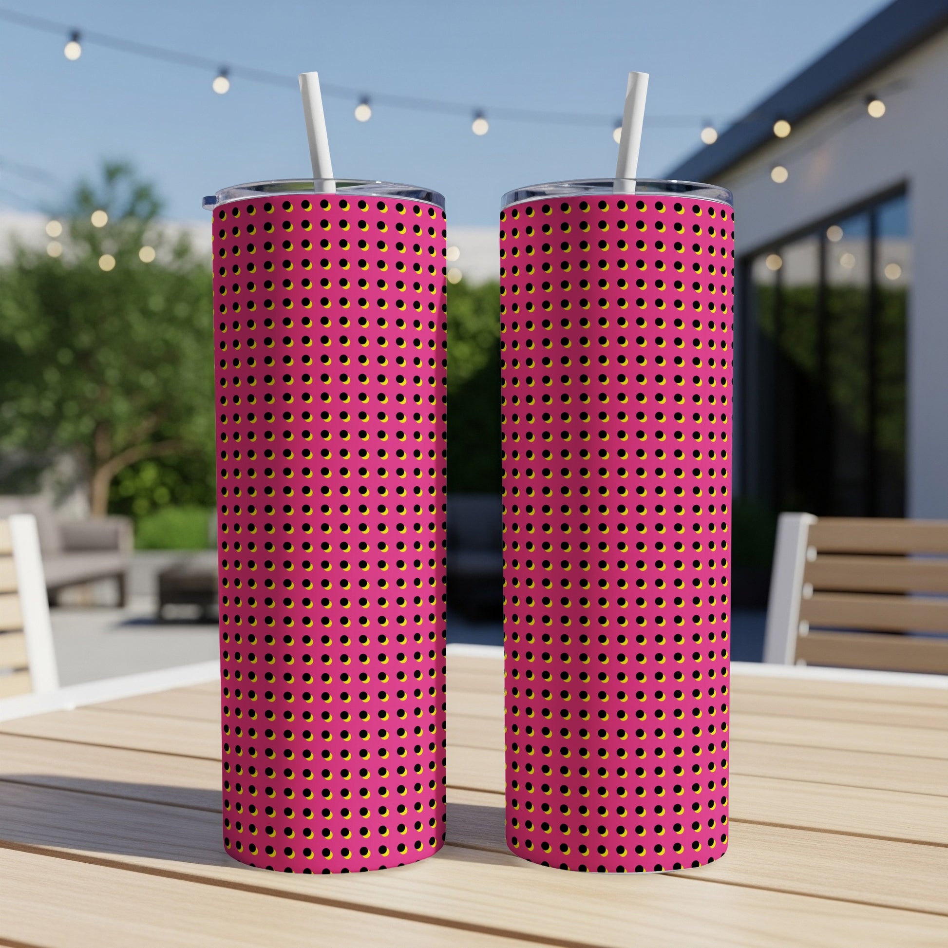 Two tall tumblers with pink background and black and yellow polka dot pattern.