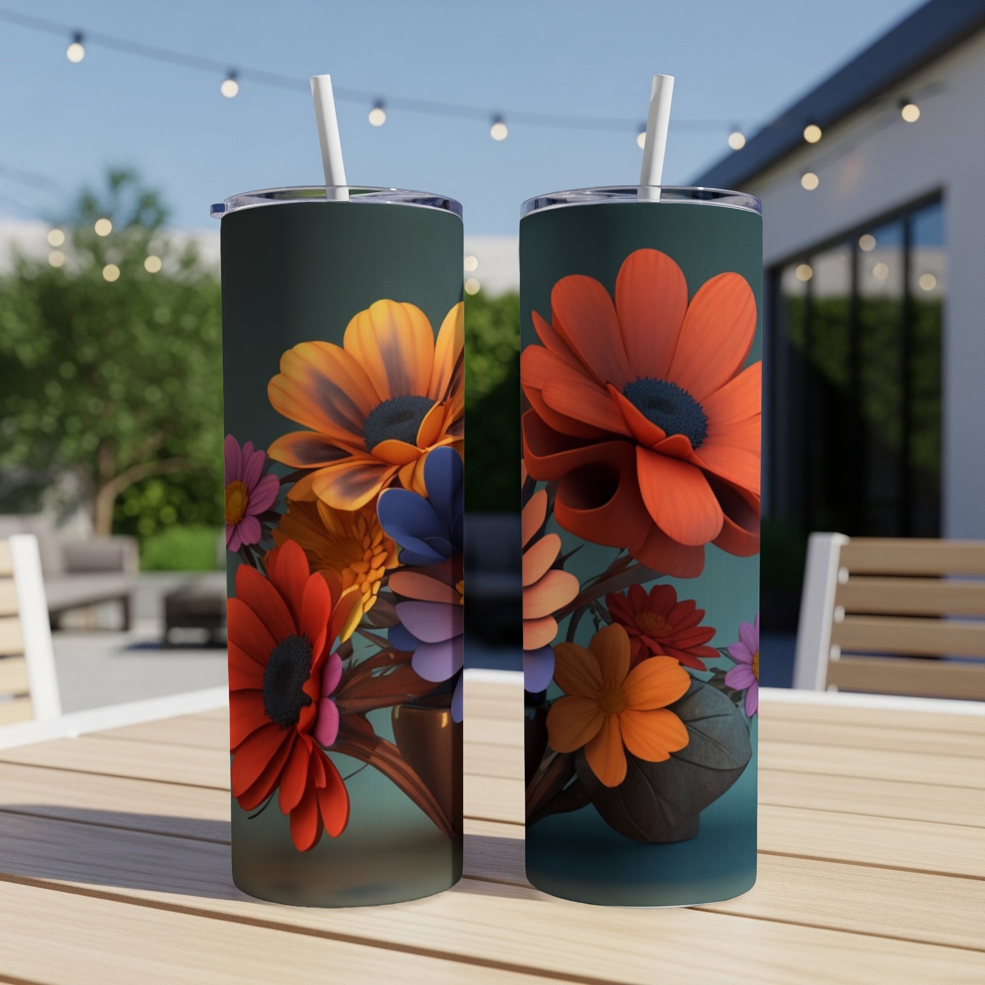 Two tumblers with vibrant orange and purple floral designs, outdoors.