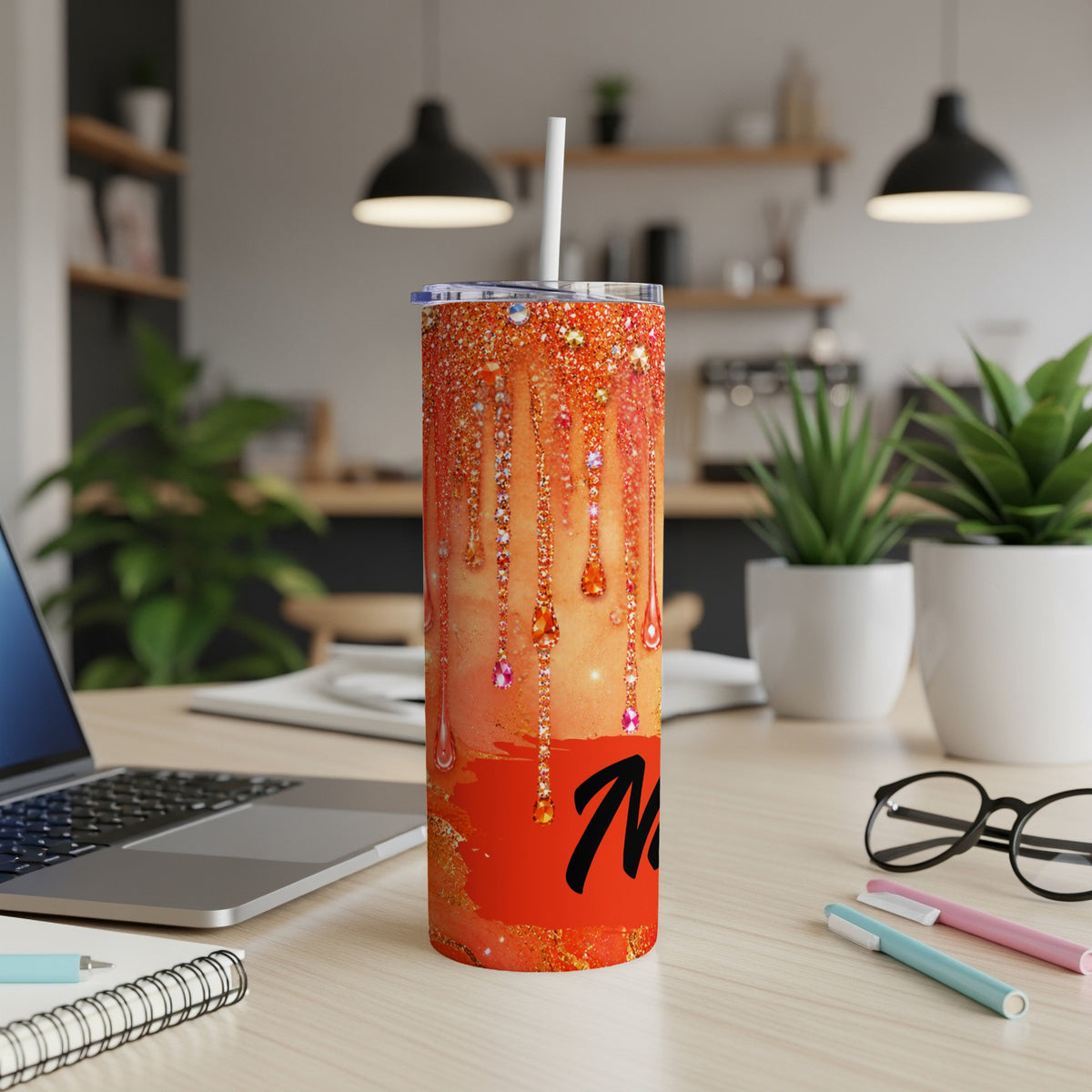 Orange glitter tumbler with dripping gem design and the letter "M".