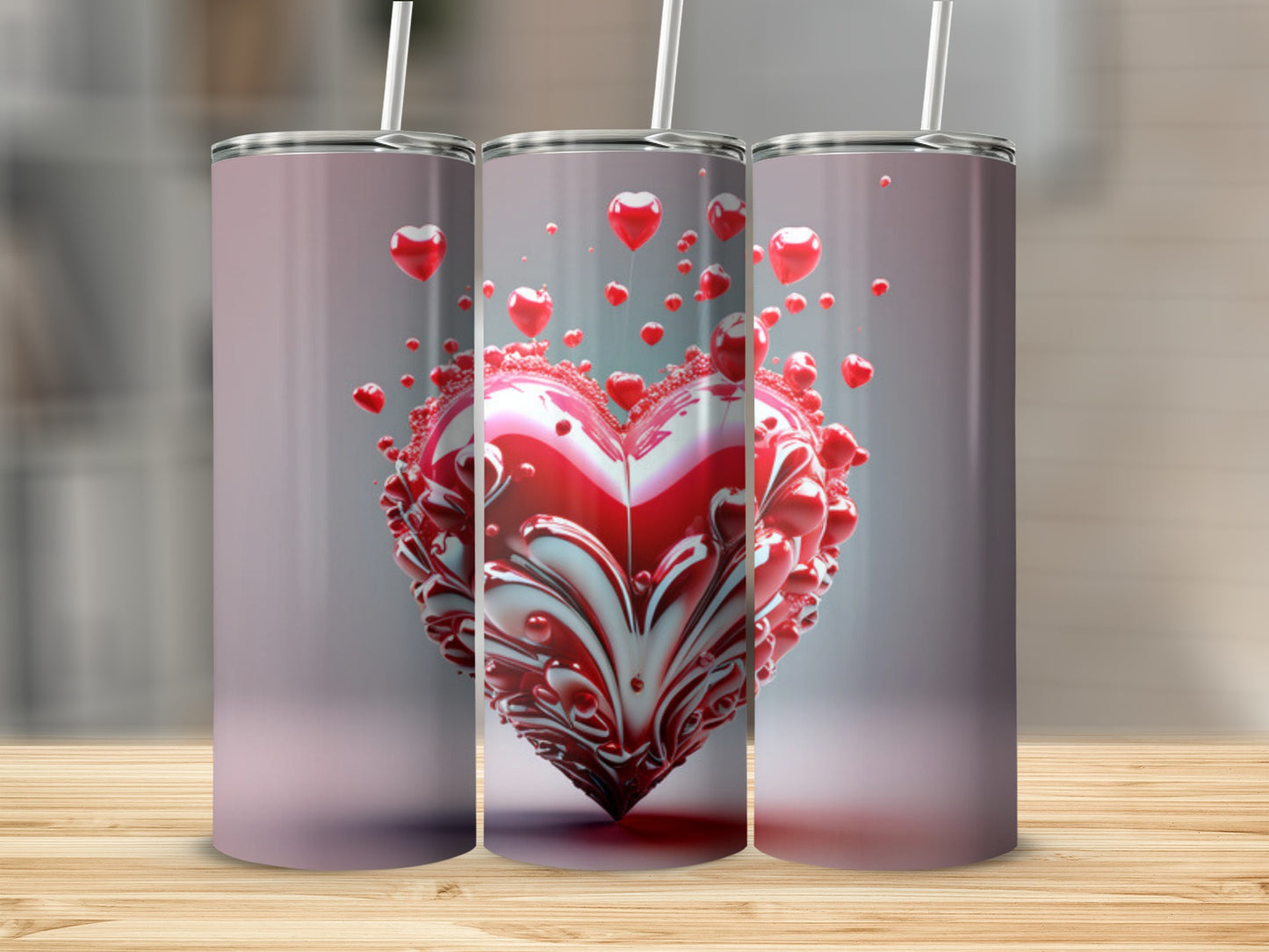 Three tumblers with a heart-shaped design and straws, displayed on a wooden surface.