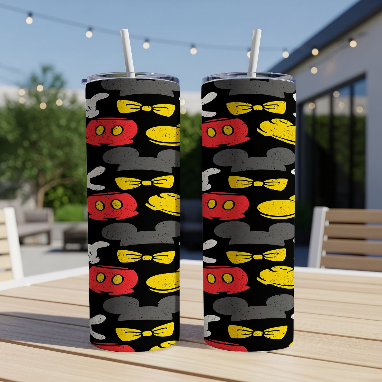 Two Mickey Mouse themed tumblers with black background and colorful character icons.