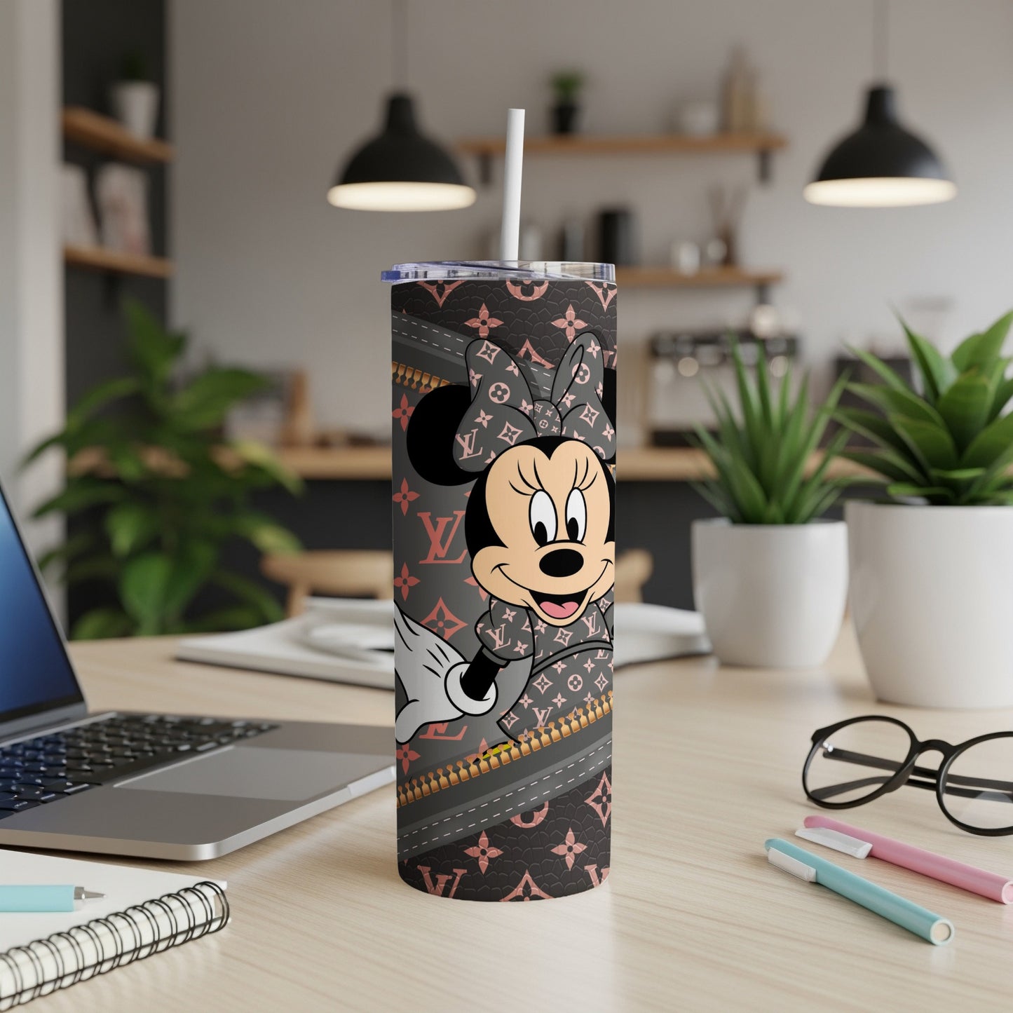 Minnie Mouse in a gray Louis Vuitton pattern tumbler with a white straw.