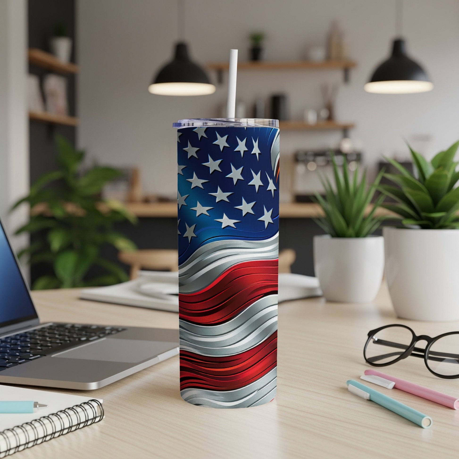 Wavy American flag tumbler with straw on a desk.