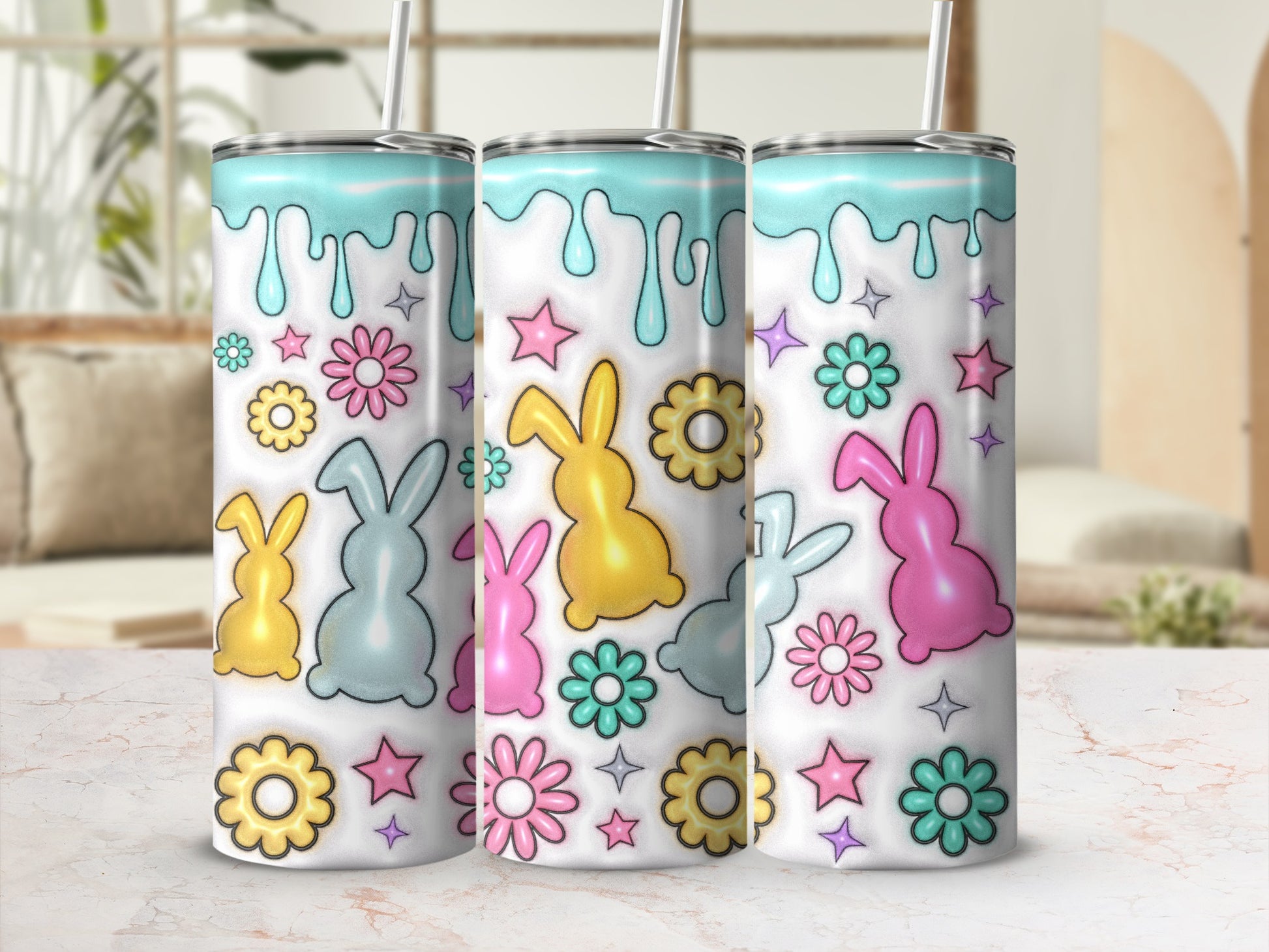 Three colorful bunny tumblers with floral and star decorations.