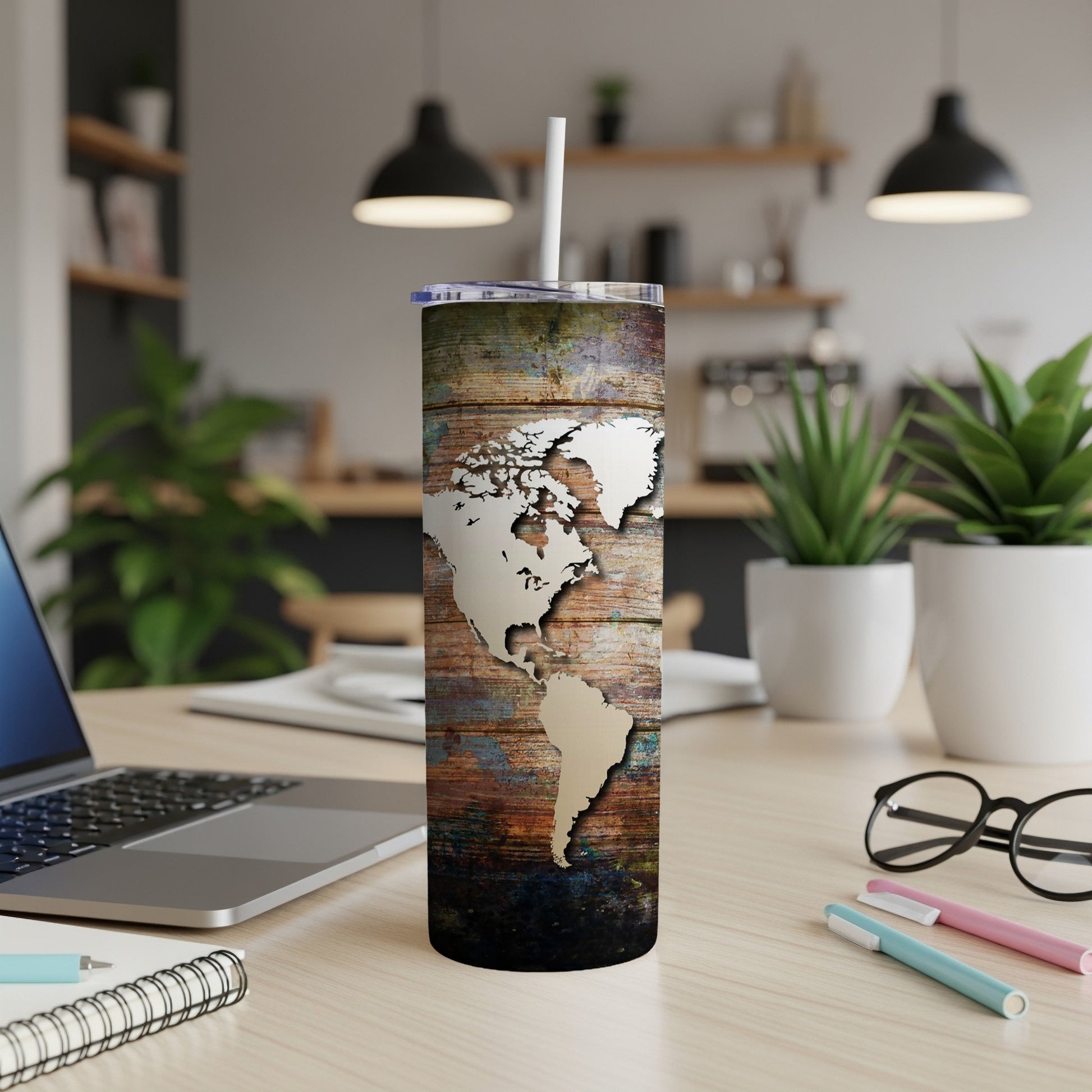 Tumbler with map design on distressed wood texture, including a straw.