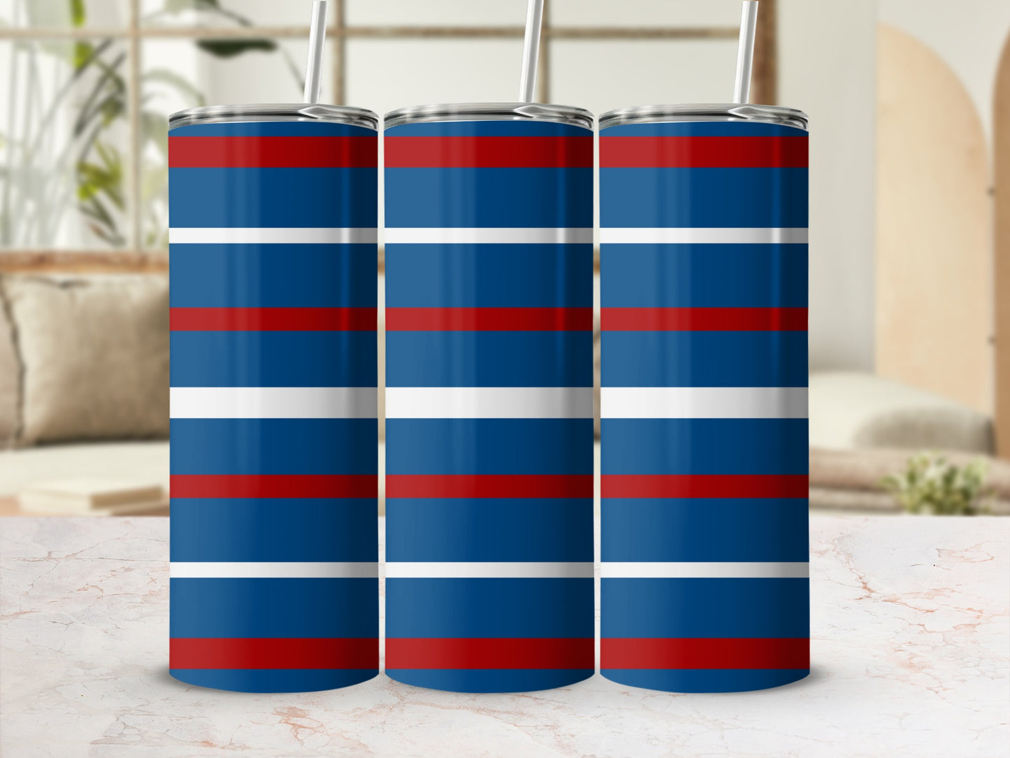 Three tumblers with red, white, and blue horizontal stripes and straws.