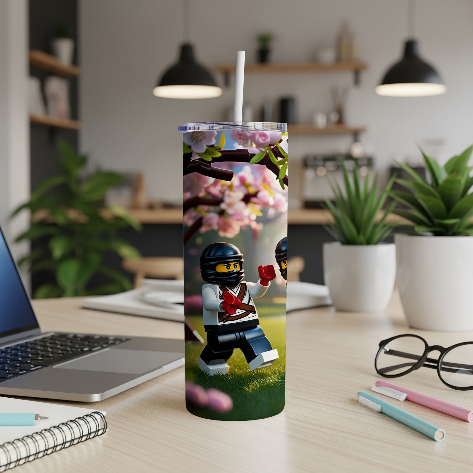Ninja minifigure on a tumbler, surrounded by cherry blossoms and grass.