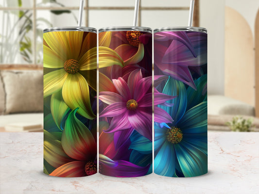 Three floral-patterned tumblers with colorful ombre petals against a blurred background.