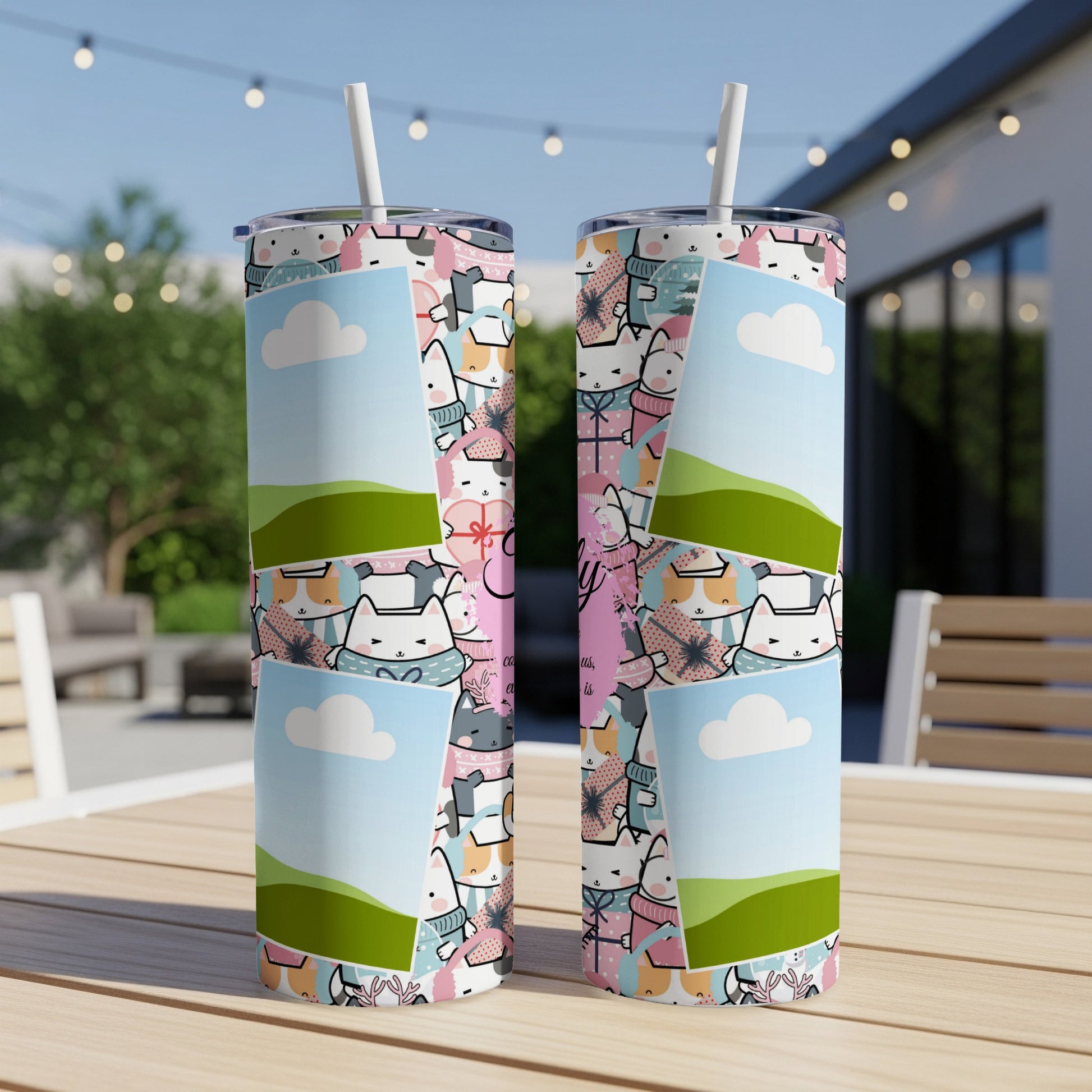 Two tumblers featuring a pattern of cute cats and clouds on a wooden table.