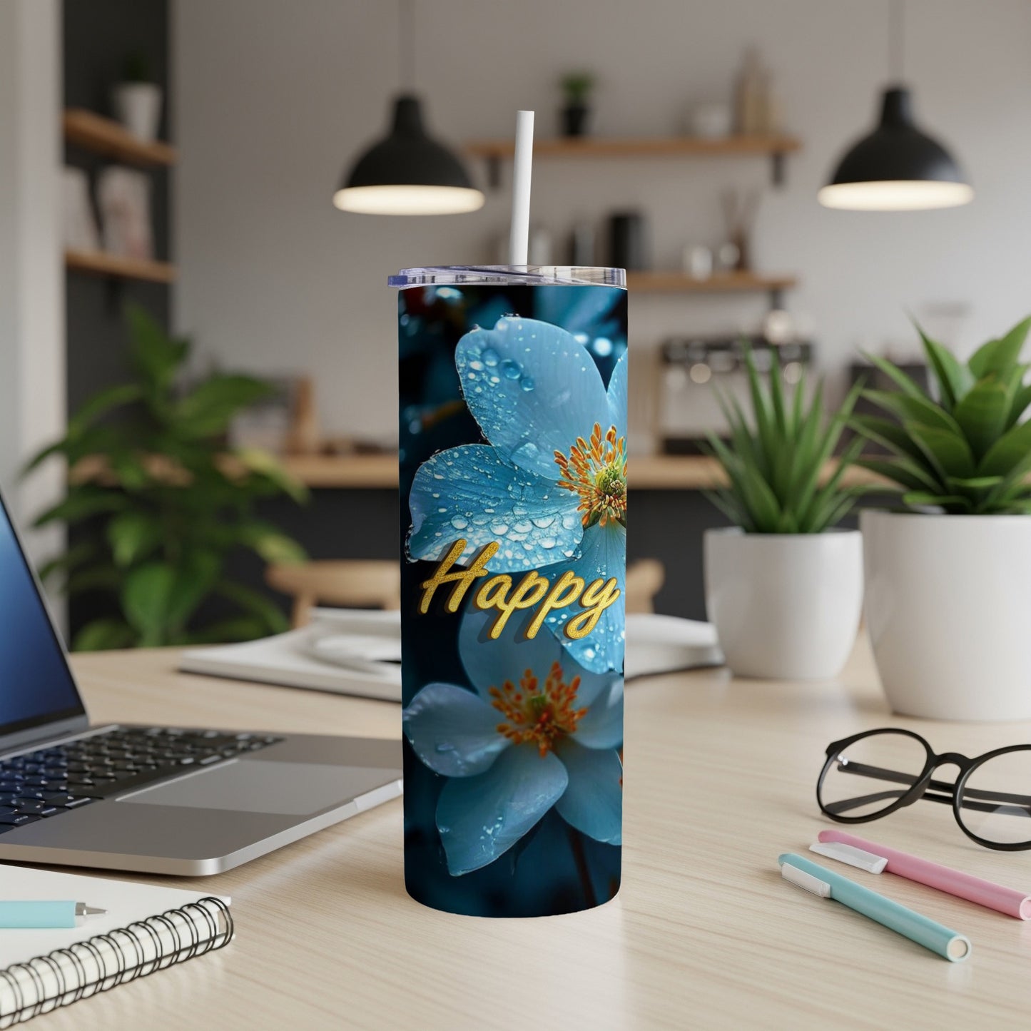 Blue flower with water droplets, "Happy" text on a skinny tumbler.