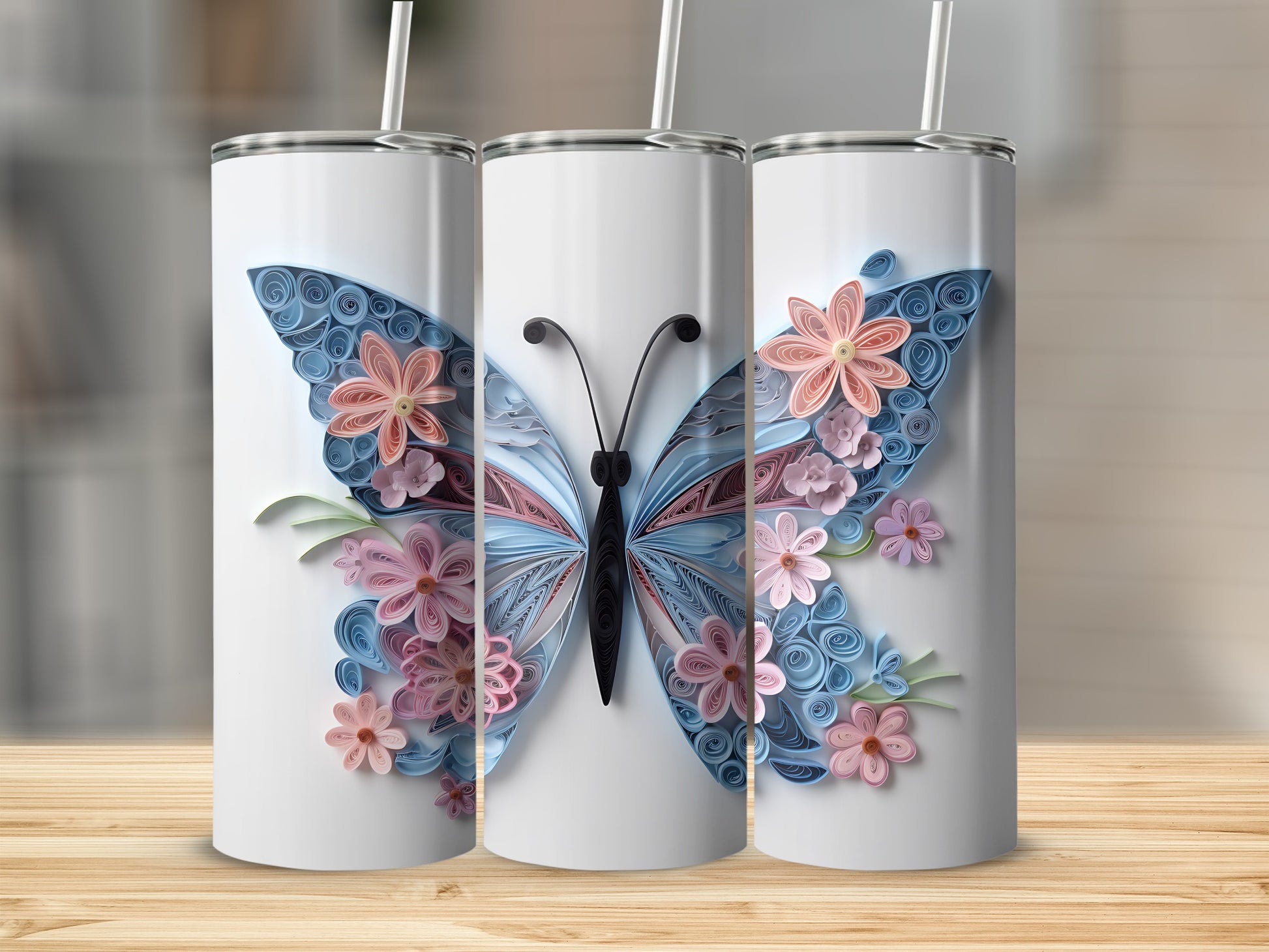Three tumblers featuring a quilled paper butterfly with pink and blue flowers.