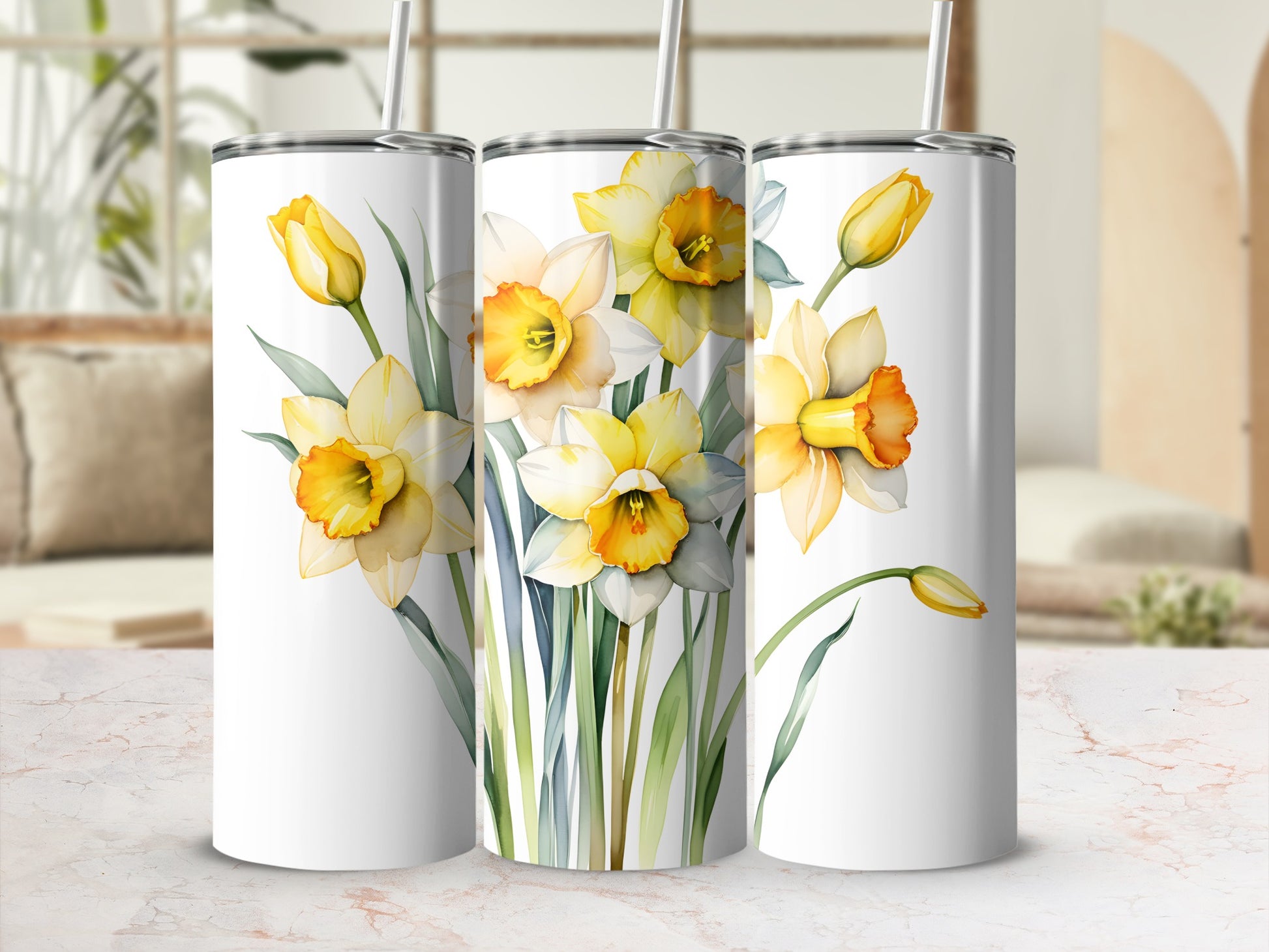 Three white tumblers featuring watercolor daffodils and greenery.