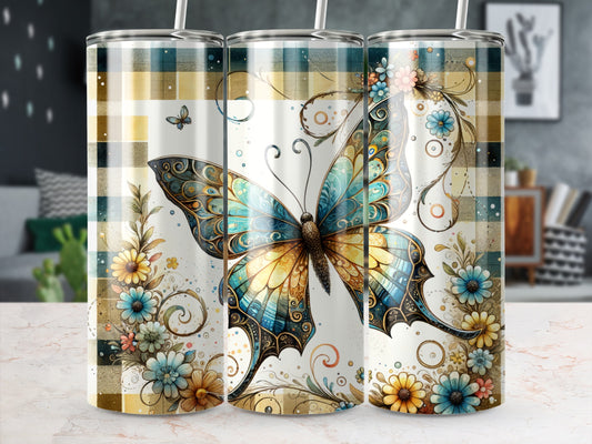 Tall tumbler with ornate butterfly and floral design on plaid background.