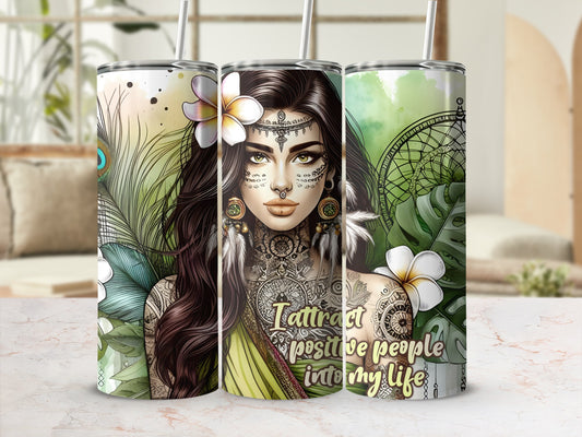 Woman with tattoos and flowers on a tumbler with text "Attract positive people into my life."