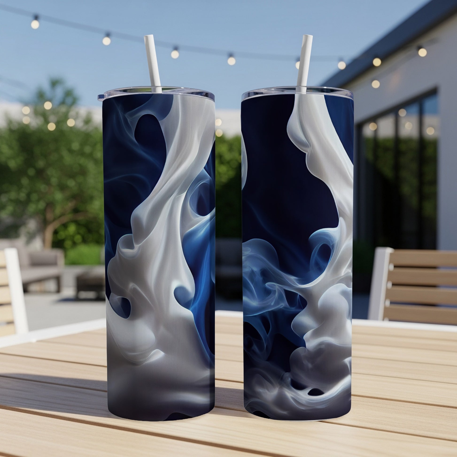 Two blue and white smoke effect tumblers on a table outdoors.