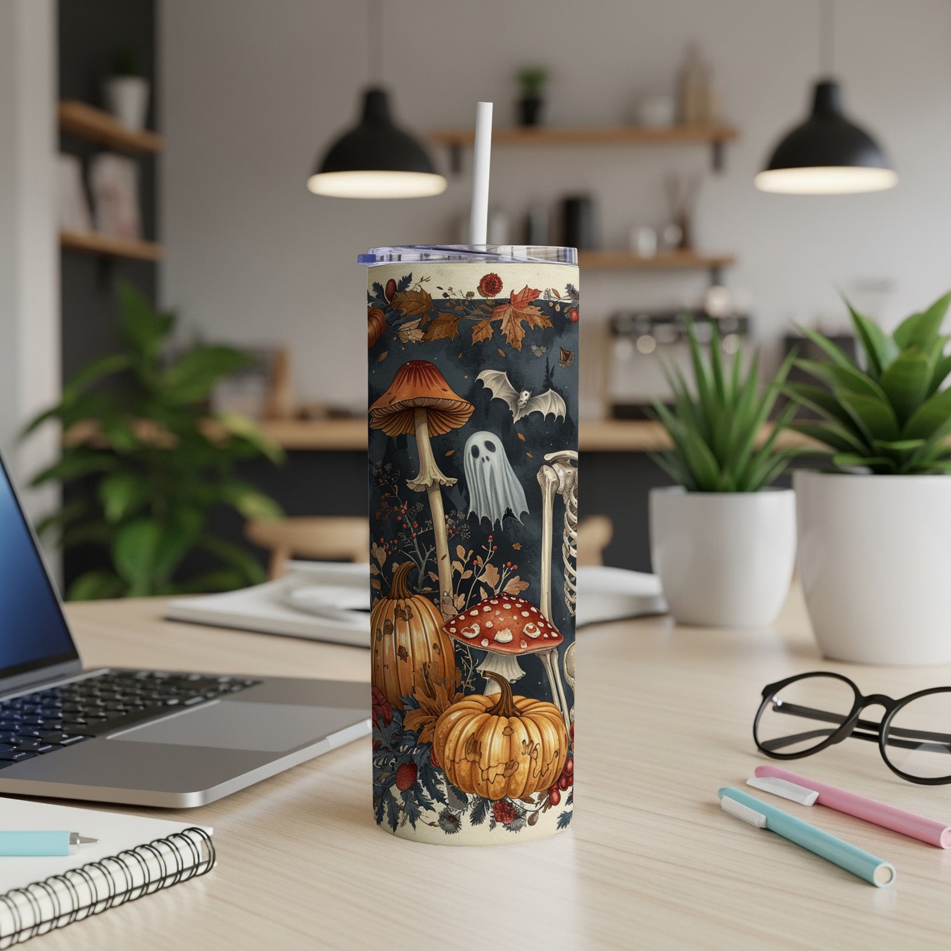 Tumbler with Halloween mushrooms, pumpkins, ghost, bat, and skeleton illustration.