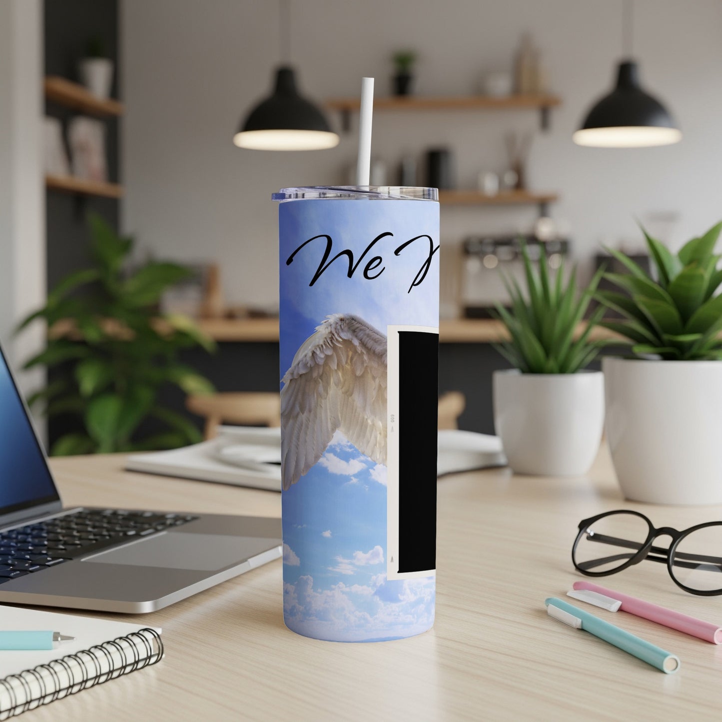 Tumbler with white angel wings on a blue sky background, "We Joy" text.