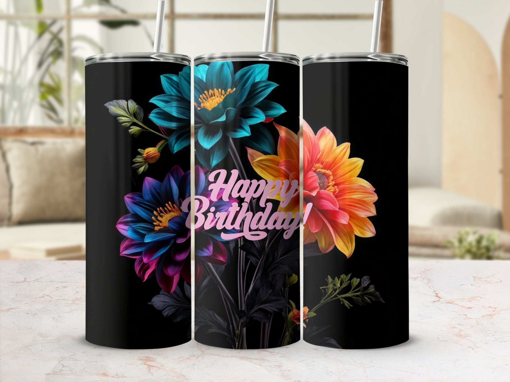 Three black tumblers with colorful floral designs and "Happy Birthday" text.