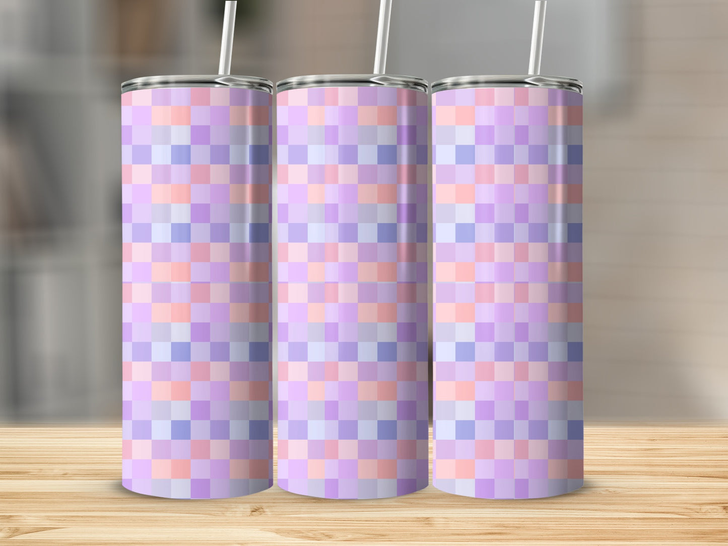 Three tall tumblers with a pastel plaid geometric pattern.