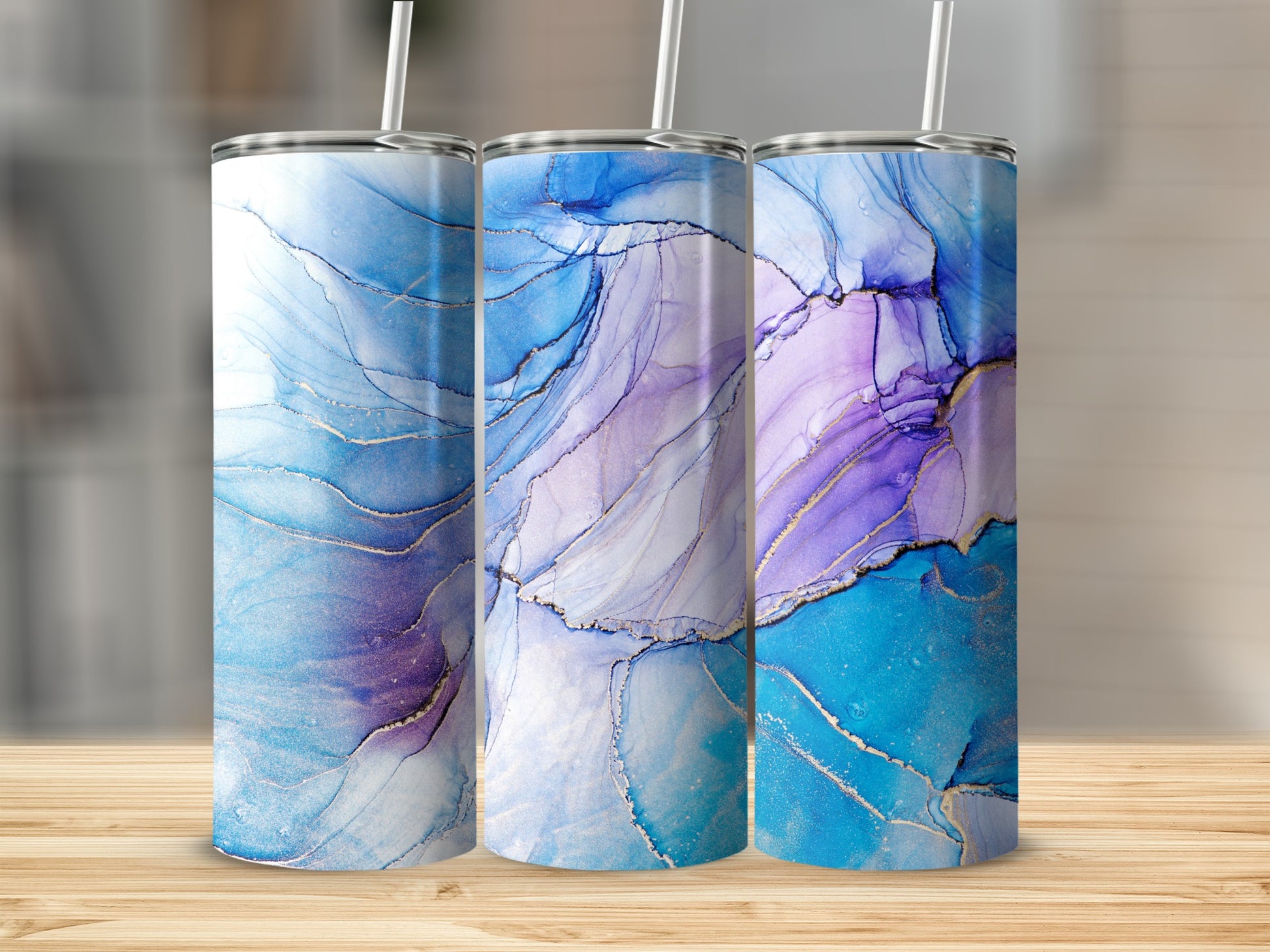 Three tumblers with blue and purple abstract watercolor designs.