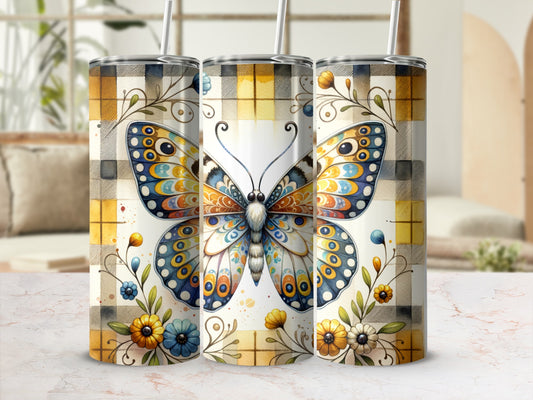 Tumbler with a colorful butterfly and floral pattern on a plaid background.