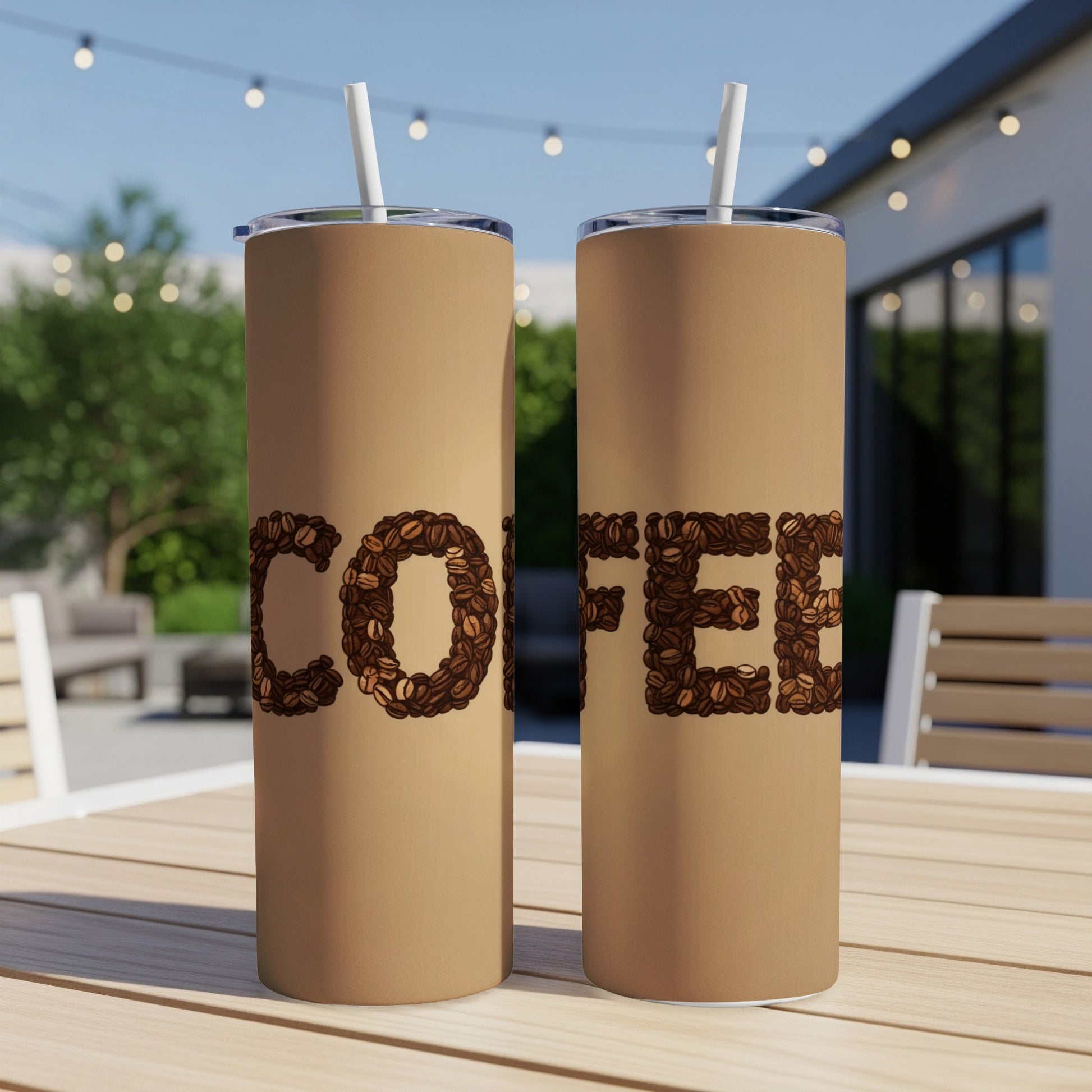 Two brown tumblers with "COFFEE" spelled in coffee beans on a wooden table.