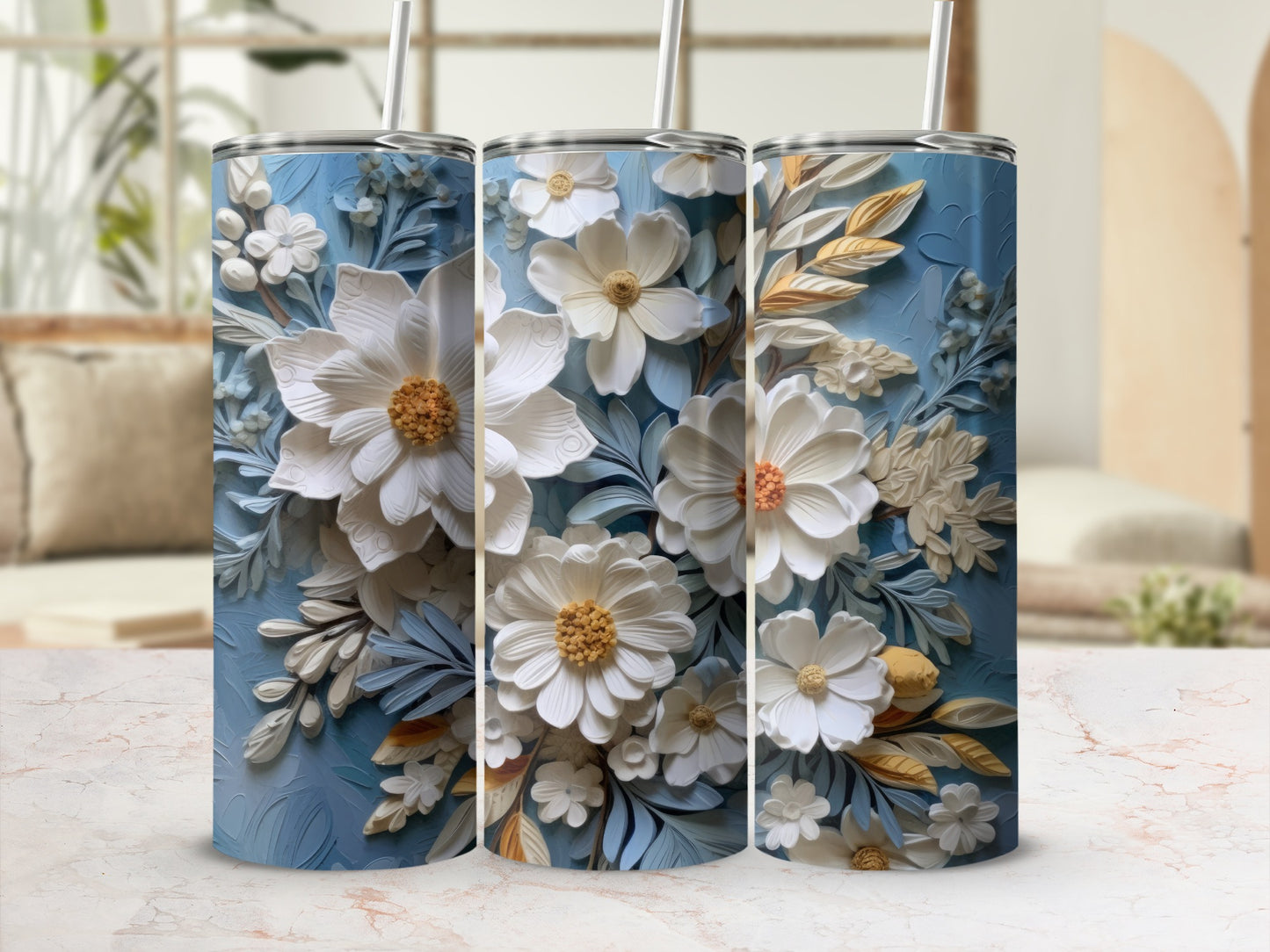 Three blue tumblers with detailed white and gold floral designs.