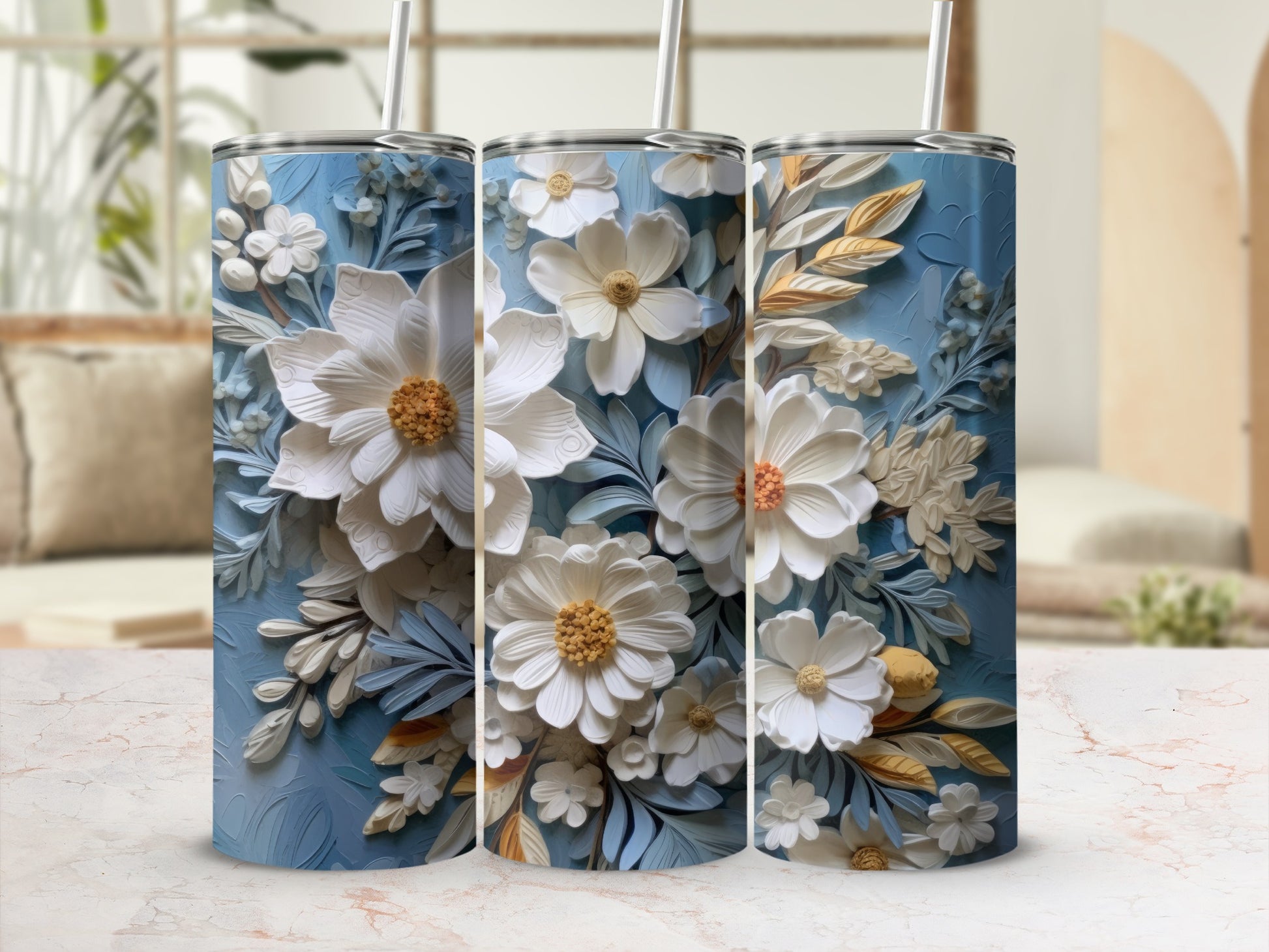 Three blue tumblers with detailed white and gold floral designs.
