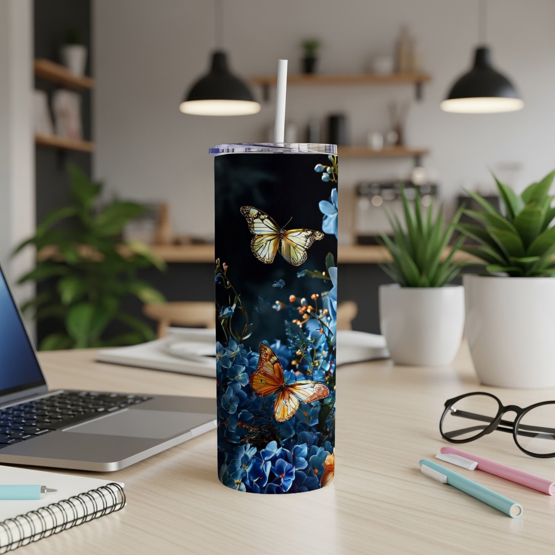 Tall tumbler with butterflies and blue floral pattern.