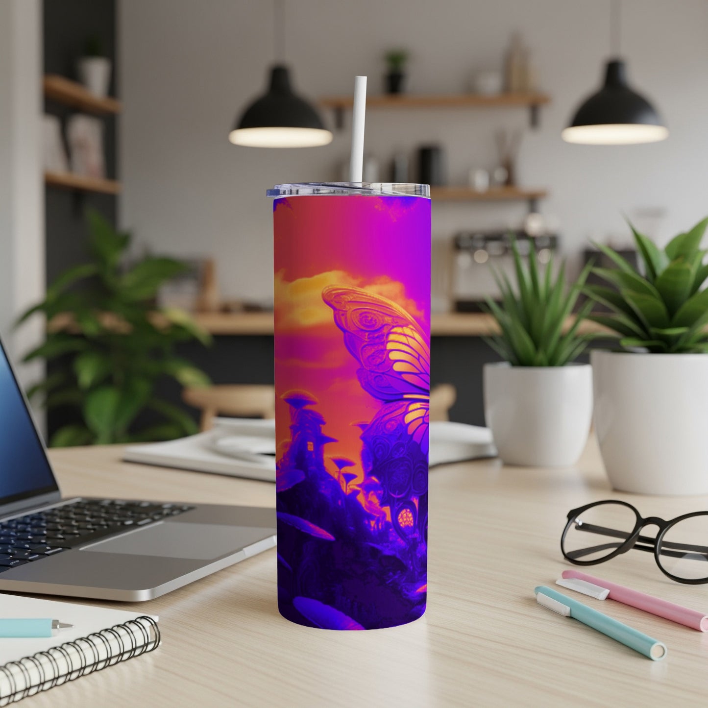 Purple and pink butterfly design on a skinny tumbler with a straw.