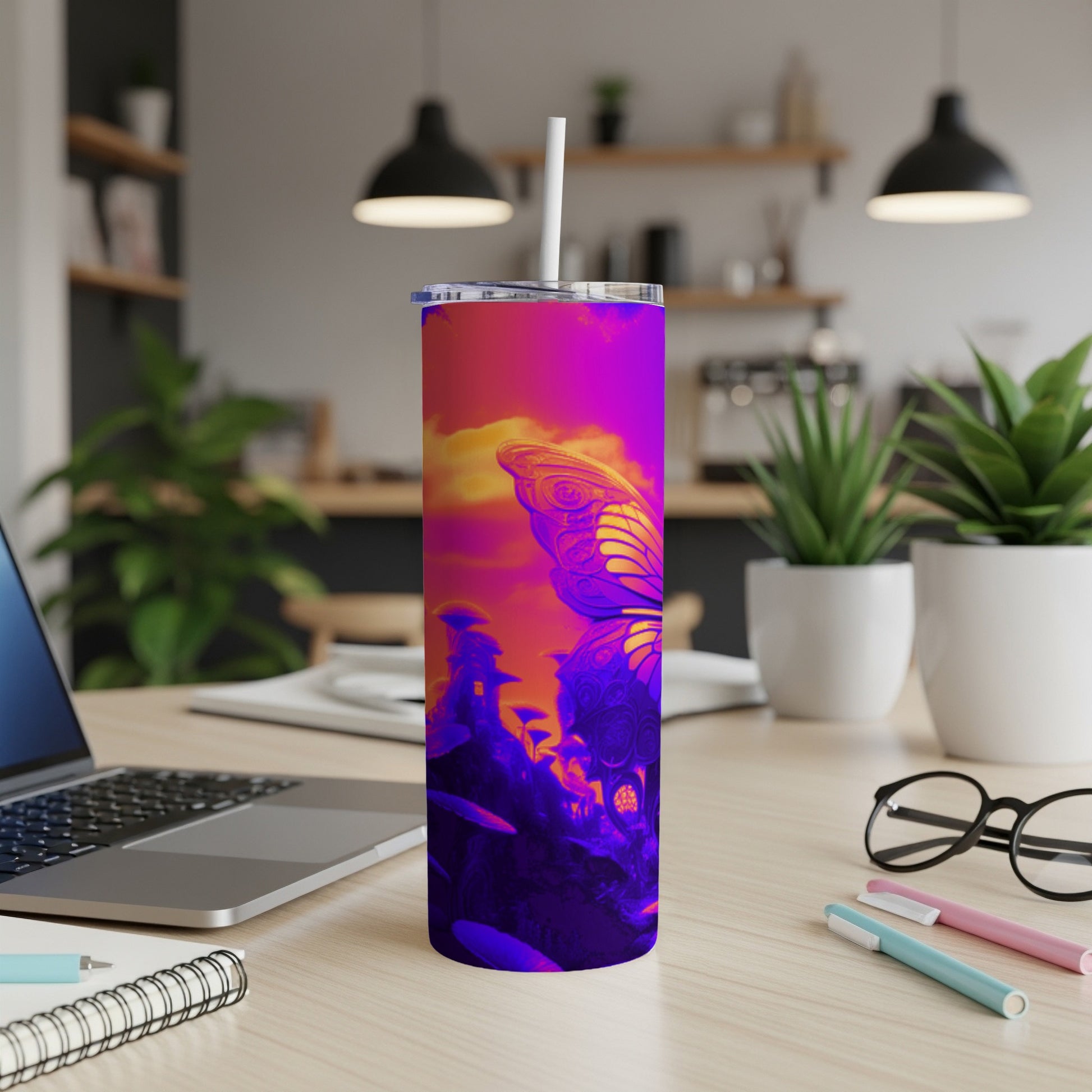 Purple and pink butterfly design on a skinny tumbler with a straw.