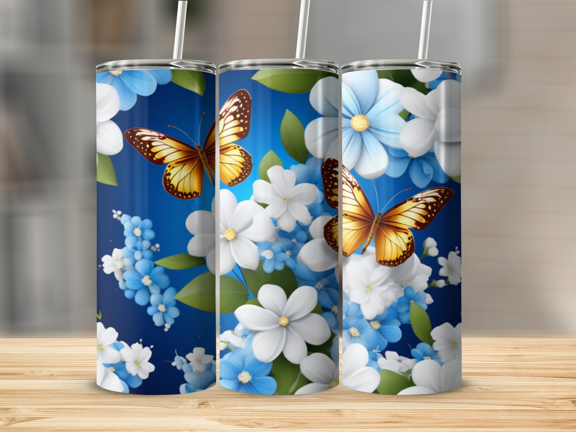 Blue tumbler with butterflies and white and blue flowers.