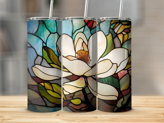 Stained glass magnolia flower design on three tumblers.