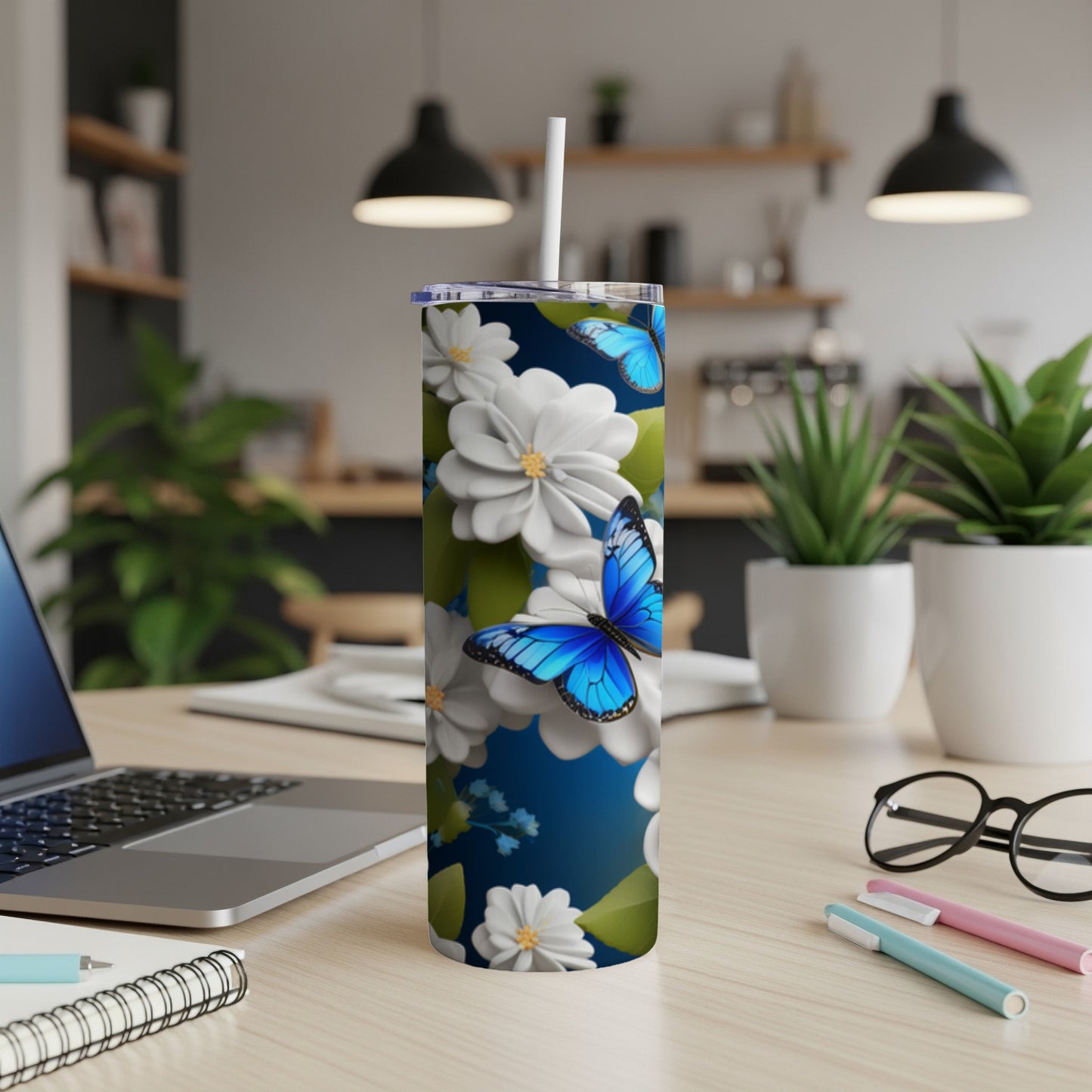 Blue butterfly and white flowers on a blue floral patterned tumbler.