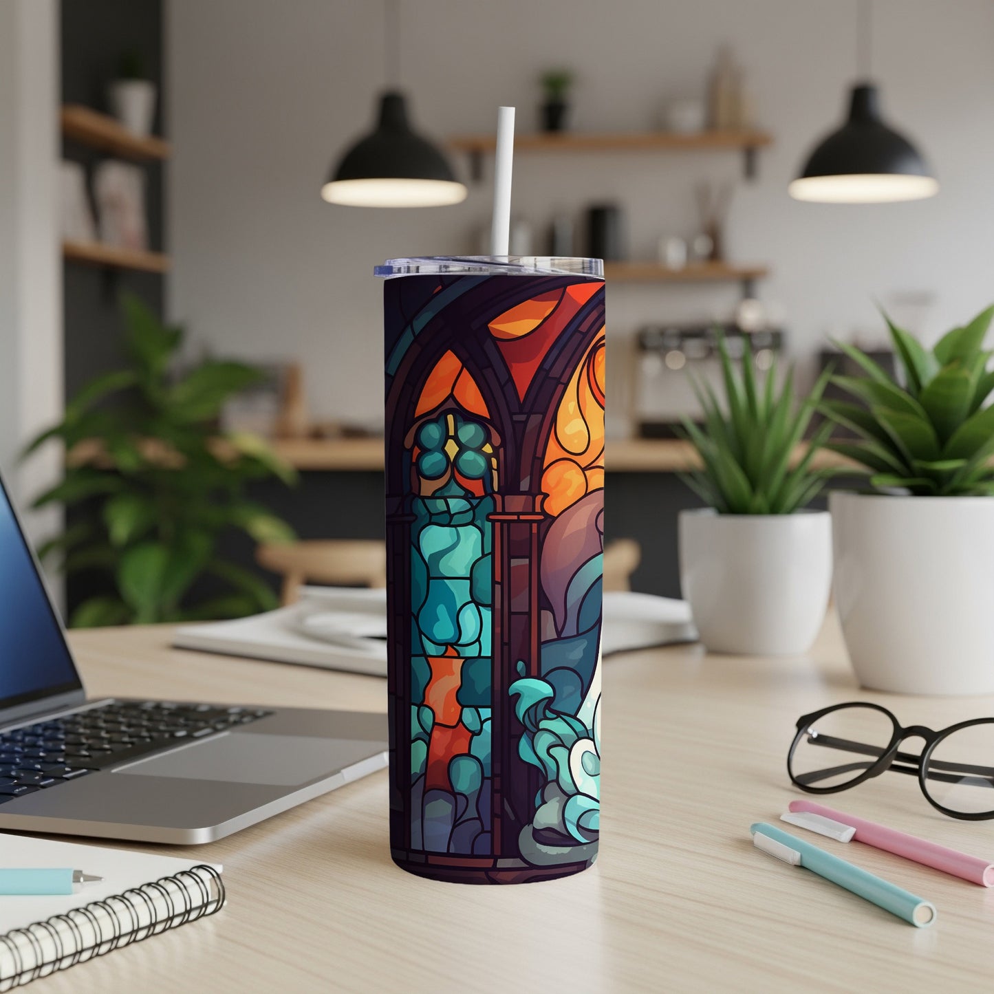 Stained glass tumbler with colorful abstract design and white straw.