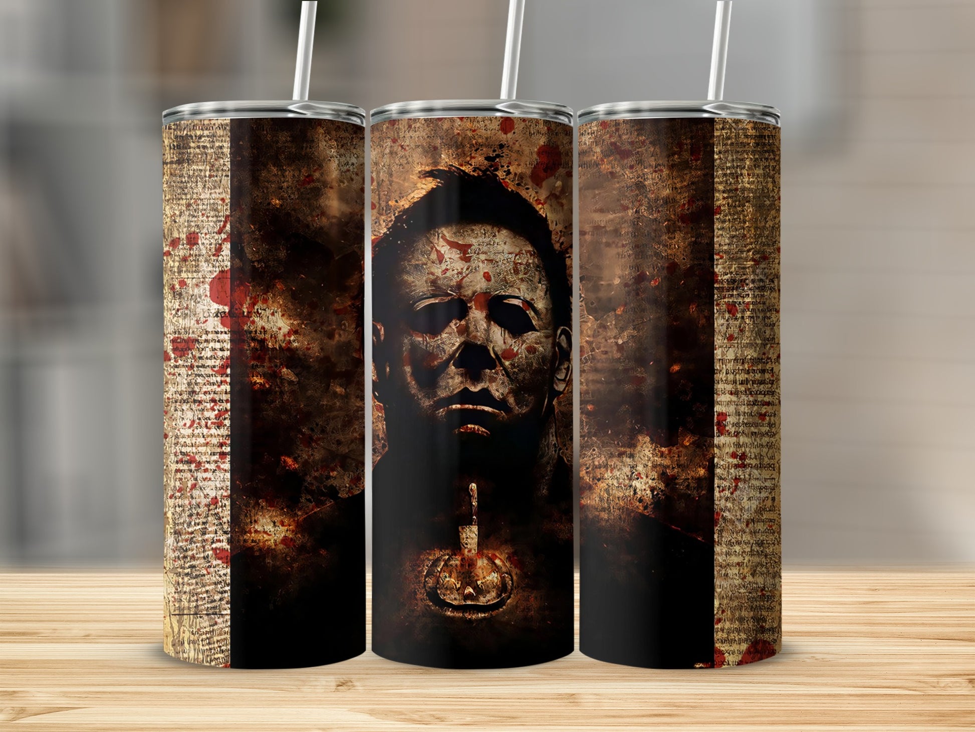 Three tumblers with a spooky design featuring Michael Myers and a bloody text pattern.