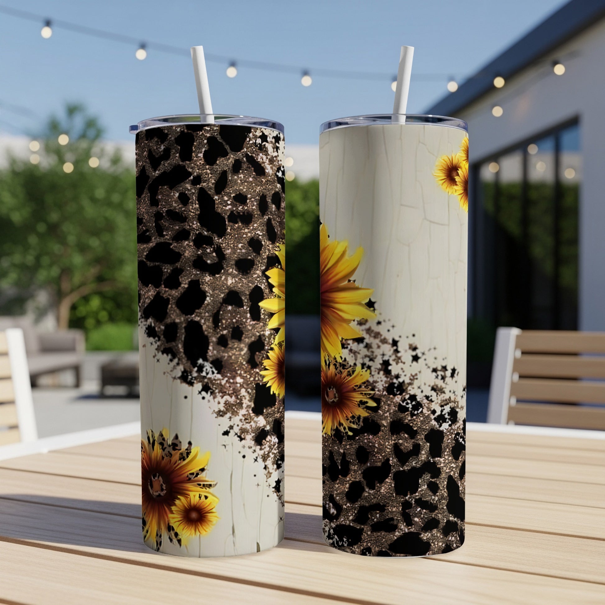 Two tumblers with sunflowers and leopard print design on a wooden table.