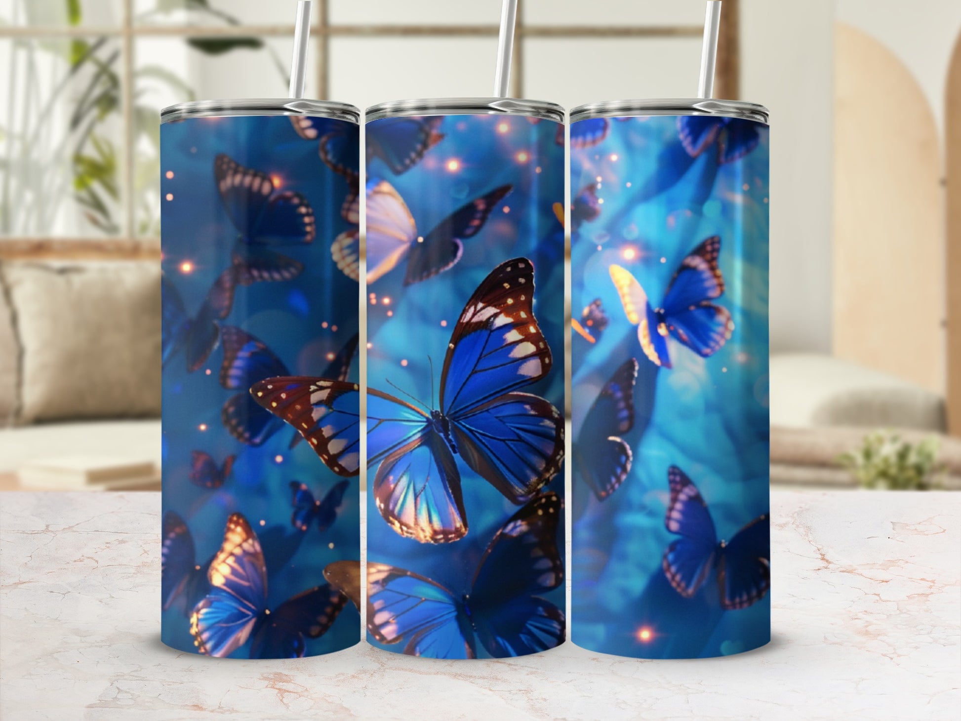 Three tumblers featuring a blue butterfly design with bokeh lights.