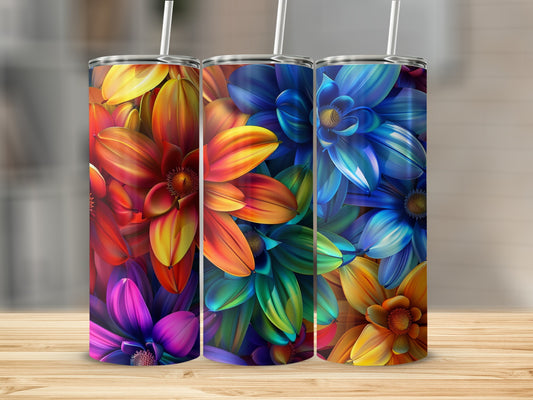 Three floral tumblers with colorful ombre designs on a wooden surface.