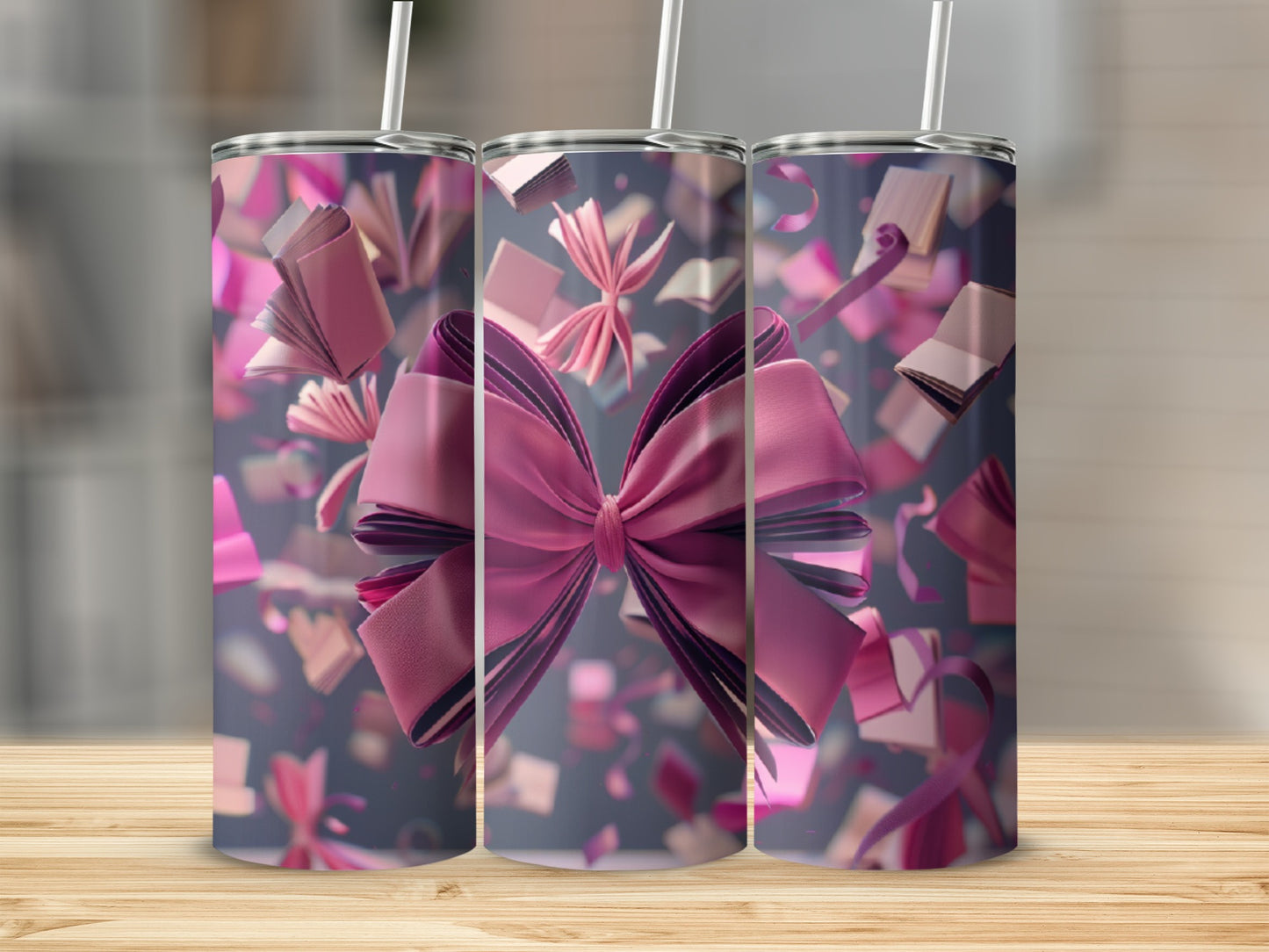 Three tumblers with pink bows and confetti floating around them.